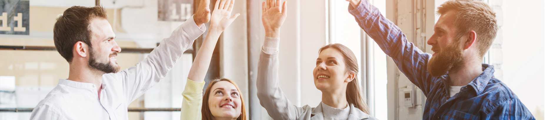 Team members celebrating success through collaboration at the workplace